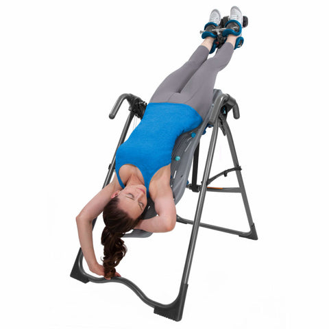 Woman using Teeter FitSpine X1 Inversion Table